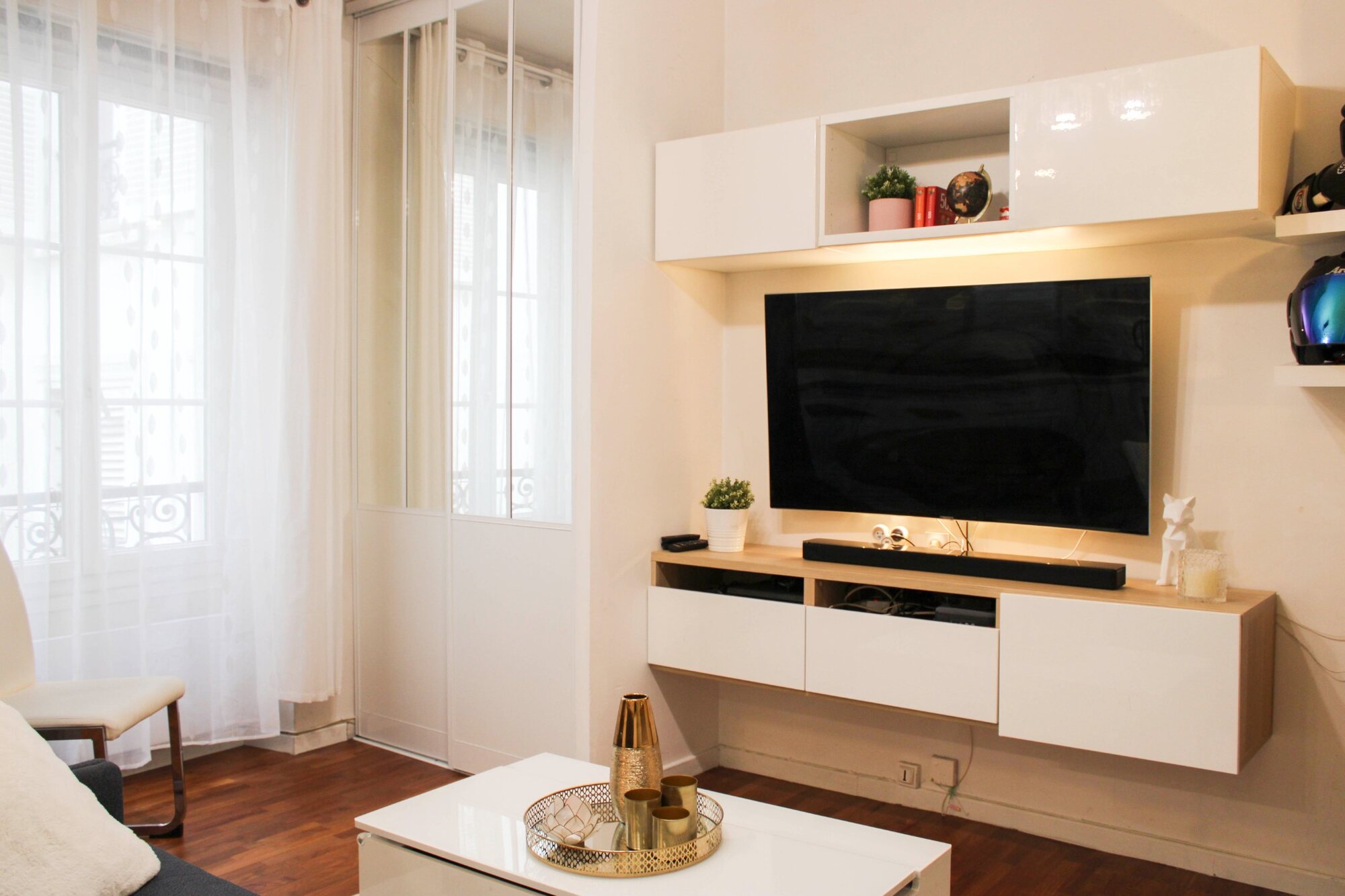 Bright living room with large windows at Saint Martin Paris Stay